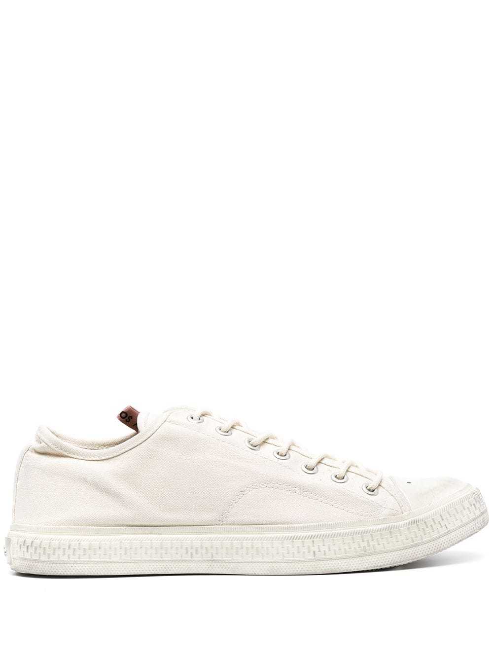 Acne Studios Perforated Canvas Sneakers, $310 | farfetch.com | Lookastic