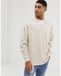 ASOS DESIGN Oversized Longline Long Sleeve T Shirt With Contrast Woven Fabric Yoke And Sleeve With Zip Pocket In Beige