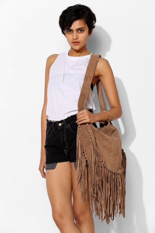Elegant outfit. Closeup of the small black suede bag with fringe. Boho  style. Fashionable girl on the street. Female fashion. City lifestyle Stock  Photo by ©victoria_red 122920064