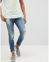 ASOS DESIGN 125oz Skinny Jeans In Mid Wash Blue With Heavy Rips