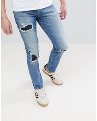 ASOS DESIGN Asos Skinny Jeans In Mid Wash Blue With Rip Repair