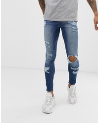 ASOS DESIGN Spray On Jeans In Power Stretch With Heavy Rips In Mid Wash Blue