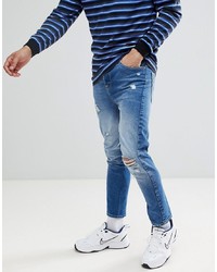 ASOS DESIGN Twisted Skinny Jeans In Mid Wash Blue With Rips