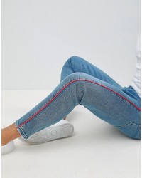 ASOS DESIGN Twisted Skinny Jeans In Light Wash Blue With Red Piping
