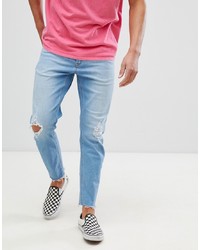 ASOS DESIGN Tapered Jeans In Vintage Light Wash With Rips