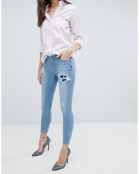 ASOS DESIGN Asos Whitby Low Rise Skinny Jeans In Mid Wash Blue With Rip And Repair