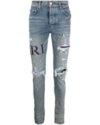 Amiri Ripped Knee Logo Print Skinny Jeans