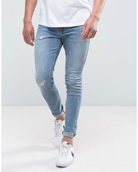 ASOS DESIGN Super Skinny Jeans In Mid Wash Blue With Abrasions