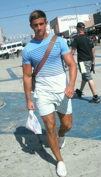 Light Blue Horizontal Striped Crew-neck T-shirt Outfits For Men: Super stylish and functional, this combo of a light blue horizontal striped crew-neck t-shirt and white shorts delivers variety. Let your styling credentials truly shine by complementing this look with a pair of white canvas low top sneakers.