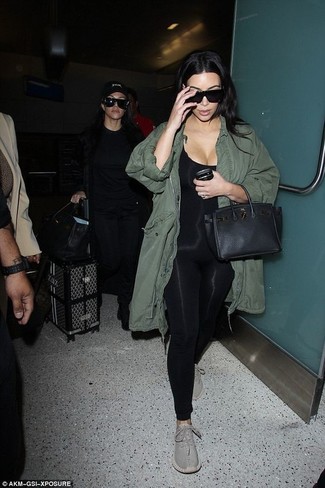 Kim Kardashian wearing Black Leather Satchel Bag, Grey Athletic Shoes, Black Jumpsuit, Olive Fishtail Parka