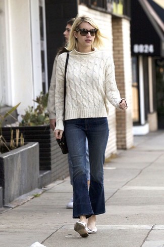 Emma Roberts wearing Black Leather Crossbody Bag, Silver Leather Ballerina Shoes, Navy Flare Jeans, White Cable Sweater
