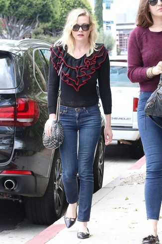 Kirsten Dunst wearing Black Studded Leather Crossbody Bag, Black Leather Ballerina Shoes, Navy Jeans, Black Ruffle Crew-neck Sweater