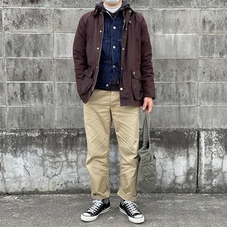 Men's Outfits 2021: A dark brown barn jacket and khaki chinos are the kind of a winning casual combination that you need when you have no time to assemble an ensemble. If you need to easily tone down this look with a pair of shoes, why not add black and white canvas low top sneakers to your ensemble?