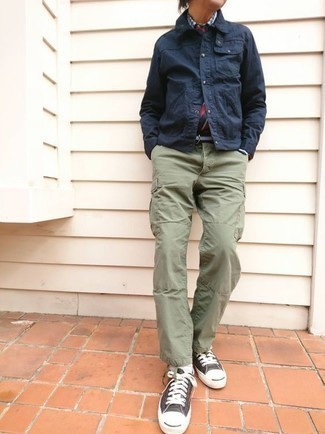 Low Top Sneakers Outfits For Men: This combination of a navy barn jacket and olive cargo pants looks awesome and makes you look instantly cooler. Introduce a pair of low top sneakers to the mix and the whole outfit will come together perfectly.