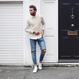 White Low Top Sneakers Outfits For Men: A beige cable sweater and blue ripped jeans are a contemporary combo that every fashion-forward guy should have in his closet. White low top sneakers are an effective way to transform this outfit.