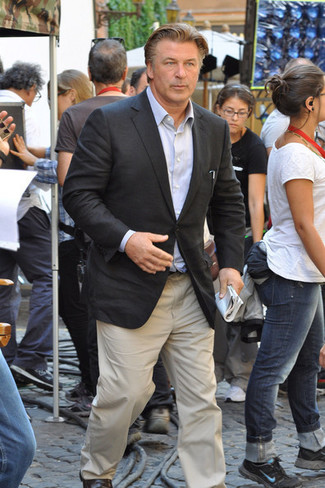 Alec Baldwin wearing Dark Brown Leather Loafers, Beige Chinos, Light Blue Long Sleeve Shirt, Charcoal Blazer