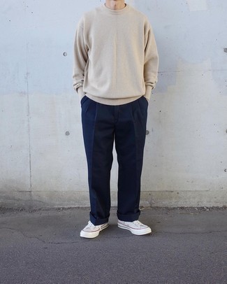 Blue Chinos Outfits: This off-duty pairing of a beige crew-neck sweater and blue chinos is a foolproof option when you need to look casually dapper but have no time to pick out a look. Add white canvas low top sneakers to the equation to effortlessly rev up the street cred of this outfit.