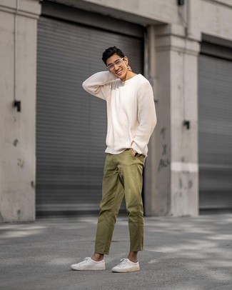 Beige Crew-neck Sweater Outfits For Men: If you're looking for a casual yet sharp ensemble, dress in a beige crew-neck sweater and olive chinos. If you want to effortlessly tone down this getup with one single piece, why not introduce a pair of white canvas low top sneakers to the mix?