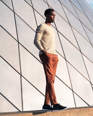 Beige Crew-neck Sweater with Brown Chinos Fall Outfits: This combination of a beige crew-neck sweater and brown chinos is hard proof that a safe casual getup doesn't have to be boring. Dial down the dressiness of this look by finishing off with a pair of black leather low top sneakers. It's a viable option if you're picking out a well-coordinated getup for transitional weather.