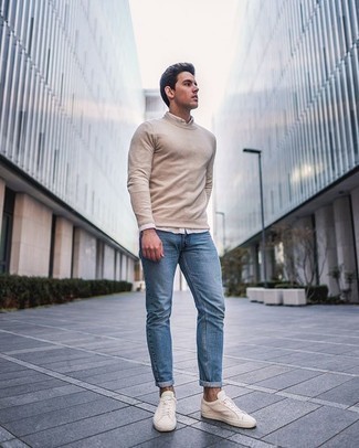 Beige Crew-neck Sweater Casual Outfits For Men: Go for a beige crew-neck sweater and light blue jeans for both seriously stylish and easy-to-style ensemble. Our favorite of a ton of ways to complement this look is with beige canvas low top sneakers.