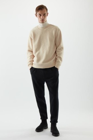 Beige Crew-neck Sweater Outfits For Men: This relaxed combo of a beige crew-neck sweater and black chinos comes to rescue when you need to look good in a flash. A trendy pair of black suede chelsea boots is a simple way to add a confident kick to the outfit.