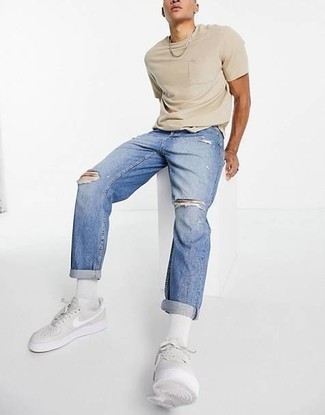 Grey Leather Low Top Sneakers Outfits For Men: If it's ease and practicality that you're searching for in an outfit, go for a beige crew-neck t-shirt and blue ripped jeans. If you need to easily ramp up your look with footwear, add grey leather low top sneakers to the mix.