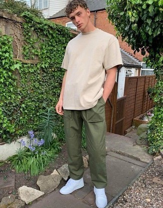 Beige Crew-neck T-shirt Outfits For Men: Why not opt for a beige crew-neck t-shirt and olive chinos? As well as very practical, both of these pieces look amazing worn together. When it comes to footwear, this ensemble pairs well with white leather low top sneakers.