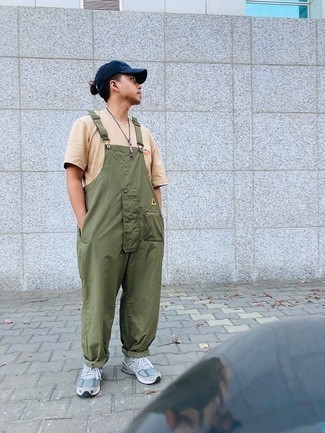 Olive Overalls Outfits For Men: For a look that brings comfort and dapperness, pair a beige crew-neck t-shirt with olive overalls. Let your sartorial prowess truly shine by finishing your outfit with a pair of light blue athletic shoes.