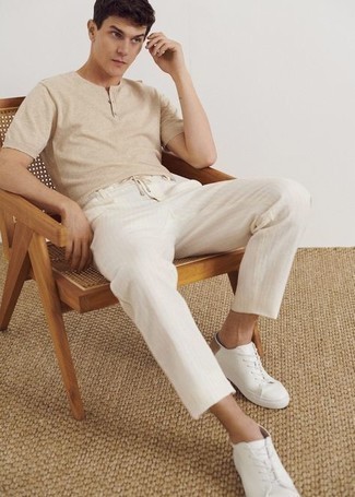 White and Navy Vertical Striped Chinos Outfits: This combination of a beige henley shirt and white and navy vertical striped chinos is extra stylish and creates instant appeal. Let your styling sensibilities truly shine by finishing off with a pair of white canvas low top sneakers.
