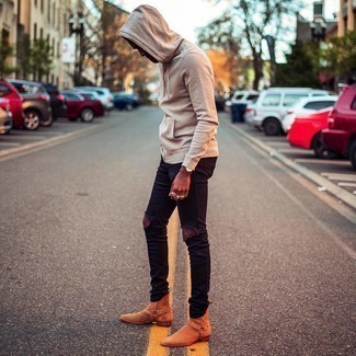 Tobacco Suede Chelsea Boots Outfits For Men: Definitive proof that a beige hoodie and black ripped skinny jeans look awesome when paired up in a modern casual look. Feeling transgressive today? Jazz things up with tobacco suede chelsea boots.