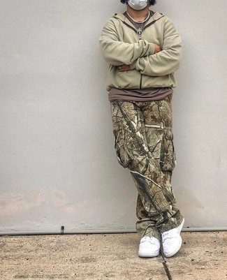 Beige Hoodie Outfits For Men: This casual pairing of a beige hoodie and olive camouflage cargo pants is clean, seriously stylish and super easy to replicate. Complete this getup with white leather low top sneakers to avoid looking too casual.