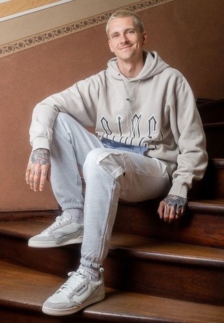 Beige Print Hoodie Outfits For Men: Go for something practical yet on-trend with a beige print hoodie and grey cargo pants. Make a bit more effort with shoes and introduce white canvas low top sneakers to the equation.