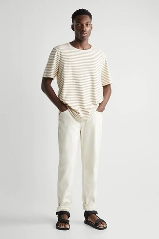 Black Canvas Sandals Outfits For Men: Show off your skills in menswear styling by opting for this modern casual combination of a beige horizontal striped crew-neck t-shirt and white jeans. If you want to easily dress down this look with footwear, introduce black canvas sandals to the mix.