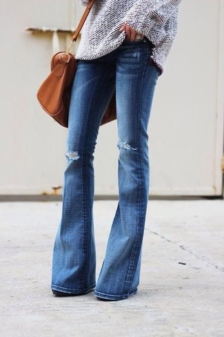 Blue Flare Jeans Outfits: If you don't take fashion too seriously, go for an off-duty outfit in a beige knit oversized sweater and blue flare jeans.