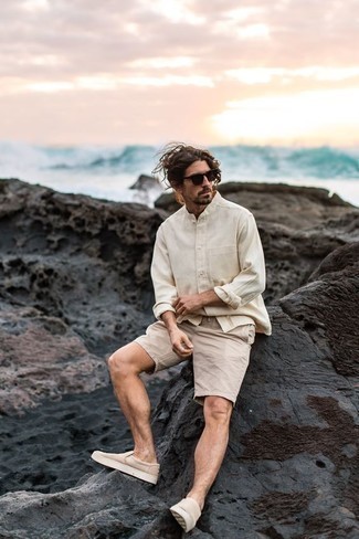 Tan Shorts Outfits For Men: You'll be amazed at how extremely easy it is for any man to get dressed this way. Just a beige long sleeve shirt worn with tan shorts. When in doubt about what to wear on the footwear front, go with a pair of beige canvas slip-on sneakers.