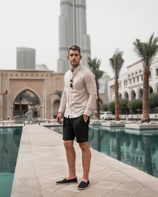 Beige Vertical Striped Long Sleeve Shirt Outfits For Men: If you gravitate towards casual style, why not opt for this pairing of a beige vertical striped long sleeve shirt and black shorts? When not sure about what to wear in the footwear department, introduce black canvas espadrilles to your ensemble.