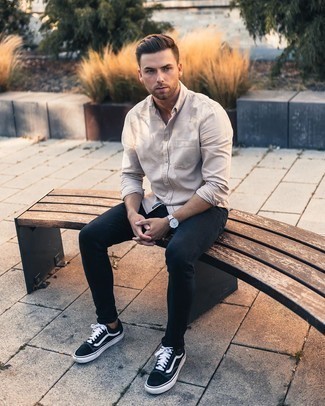 Navy Skinny Jeans Warm Weather Outfits For Men: A beige long sleeve shirt and navy skinny jeans are great menswear elements to have in the casual part of your closet. Black and white canvas low top sneakers finish this look very well.