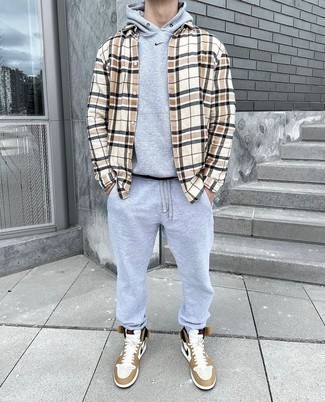 High Top Sneakers Outfits For Men: Who said you can't make a fashion statement with a city casual outfit? Turn every head in the room in a beige plaid long sleeve shirt and a grey track suit. As for footwear, add high top sneakers.