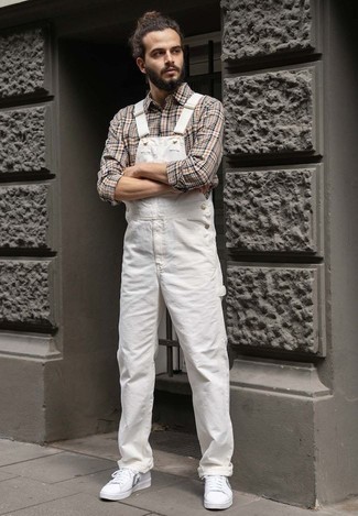 White Overalls Outfits For Men: Breathe a relaxed touch into your day-to-day styling arsenal with a beige plaid long sleeve shirt and white overalls. Puzzled as to how to finish off your outfit? Rock a pair of white print canvas low top sneakers to smarten it up.