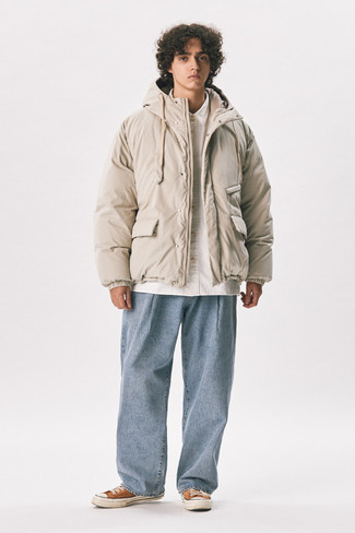 500+ Chill Weather Outfits For Men: As you can see here, looking effortlessly sleek doesn't require that much effort. Rock a beige puffer jacket with light blue jeans and be sure you'll look amazing. For a more relaxed aesthetic, why not add a pair of orange canvas low top sneakers to the equation?