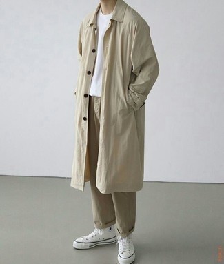 Beige Raincoat Outfits For Men: A beige raincoat and khaki chinos are a cool go-to combination to keep in your wardrobe. When this outfit looks all-too-dressy, dress it down with a pair of white canvas high top sneakers.