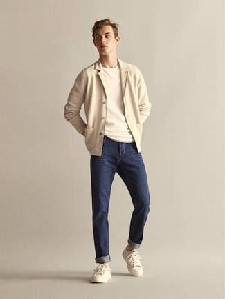 Beige Shawl Cardigan Outfits For Men: A beige shawl cardigan and navy jeans are among the key elements in any gent's functional off-duty collection. Beige canvas low top sneakers are guaranteed to add an element of stylish nonchalance to this outfit.