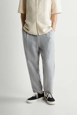 Beige Short Sleeve Shirt Outfits For Men: Pair a beige short sleeve shirt with grey chinos for a cool and relaxed and fashionable ensemble. Our favorite of a countless number of ways to finish this outfit is black and white canvas low top sneakers.
