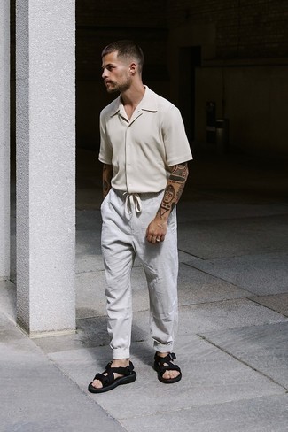 Grey Chinos Outfits: This pairing of a beige short sleeve shirt and grey chinos is an interesting balance between fun and dapper. To bring a more relaxed twist to this look, add a pair of black canvas sandals to this outfit.