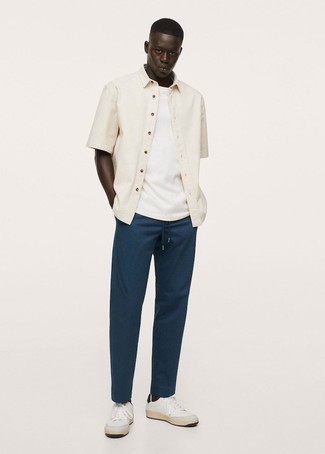 Beige Short Sleeve Shirt Outfits For Men: For a casual and cool outfit, marry a beige short sleeve shirt with navy chinos — these items work pretty good together. If you're wondering how to round off, a pair of white and black leather low top sneakers is a smart option.