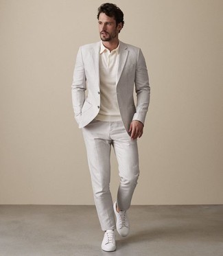 Tan Polo Outfits For Men: Marrying a tan polo and a beige suit is a guaranteed way to inject your styling arsenal with some rugged elegance. To give this outfit a more relaxed feel, why not complete this ensemble with a pair of white leather low top sneakers?