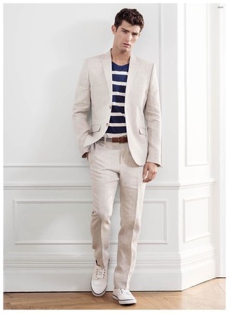 White and Black Horizontal Striped Canvas Belt Outfits For Men: Marrying a beige suit with a white and black horizontal striped canvas belt is an awesome choice for a laid-back but sharp look. Our favorite of a myriad of ways to finish this outfit is with white low top sneakers.