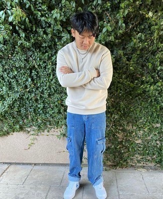 Sweatshirt Outfits For Men: Fashionable and comfortable, this off-duty pairing of a sweatshirt and blue jeans provides with wonderful styling opportunities. A great pair of white leather low top sneakers pulls this getup together.