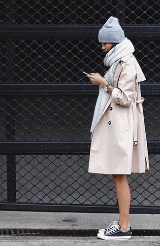 Beige Trenchcoat Outfits For Women: Demonstrate that nobody does classic and casual like you in a beige trenchcoat. A pair of black and white canvas low top sneakers instantly bumps up the appeal of your look.