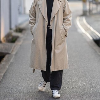 Trenchcoat Outfits For Men: Go for a simple but seriously stylish outfit pairing a trenchcoat and black chinos. White and black canvas low top sneakers will give a dose of stylish nonchalance to an otherwise standard outfit.